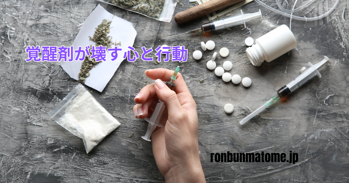 注射器や薬物が散乱する机の上で、覚醒剤を手にした人物の手元